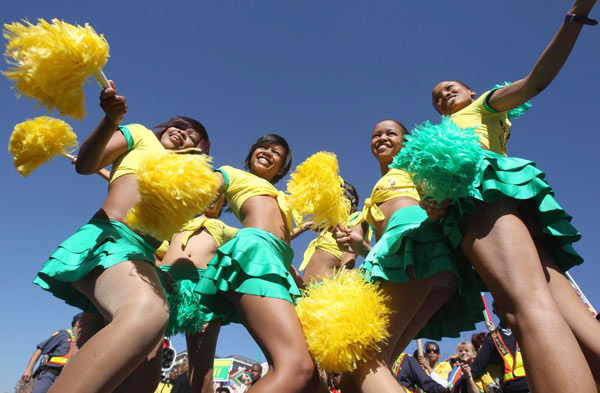 Fans celebrate as they wait for the arrival of the South Africa's national soccer team 'Bafana Bafana' during a parade on the streets of Sandton in Johannesburg June 9, 2010. 