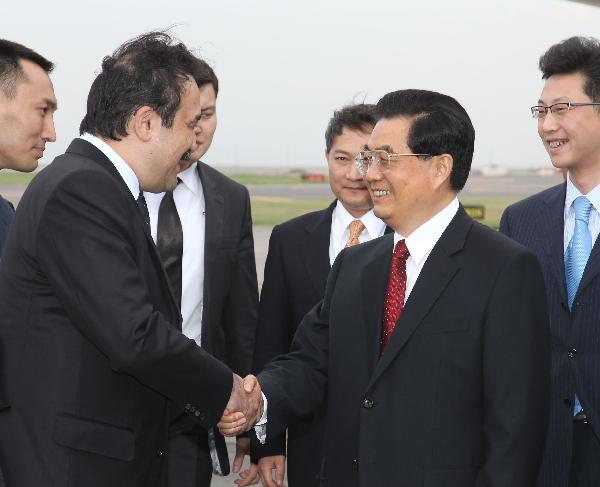 Chinese President Hu Jintao (R Front) shakes hands with Kazakh Prime Minister Karim Masimov upon his arrival in Astana for a state visit to Kazakhstan, on June 11, 2010. [Lan Hongguang/Xinhua]