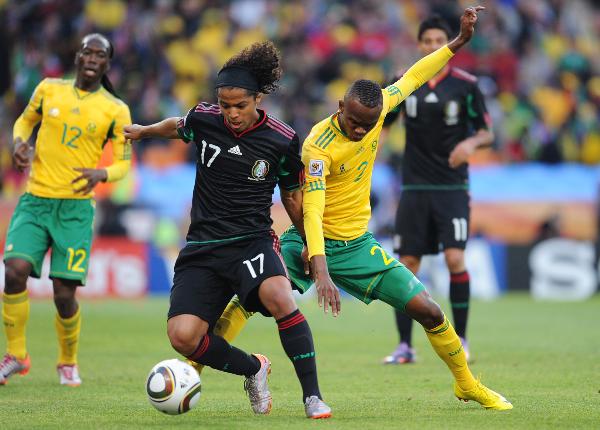 Siboniso Gaxa (R Front) of South Africa vies with Giovani Dos Santos (L Front) of Mexico during a group A match of the 2010 FIFA World Cup at Soccer City stadium in Soweto, suburban Johannesburg, on June 11, 2010. (Xinhua/Wang Yuguo) 