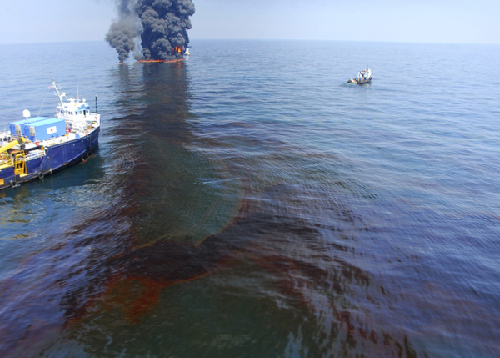 The Premier Explorer of Venice, Louisiana stands by near a controlled burn of spilled oil off the Louisiana coast in the Gulf of Mexico, in this handout photograph taken June 9, 2010 and released on June 11. [Xinhua/Reuters]