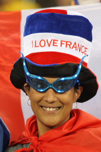 A fan of France waits for a Group A match of the 2010 FIFA World Cup between France and Uruguay at the Green Point stadium in Cape Town, South Africa, on June 11, 2010. (Xinhua/Xing Guangli)