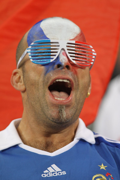 A supporter of France cheers before a Group A match of the 2010 FIFA World Cup between France and Uruguay at the Green Point stadium in Cape Town, South Africa, on June 11, 2010. (Xinhua/Xing Guangli)