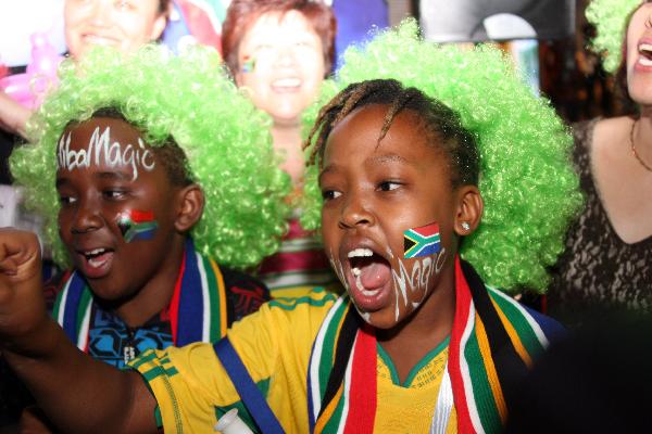 Soccer fans celebrate the opening of the 2010 FIFA World Cup in South Africa, in the South Africa Pavilion in Shanghai, east China, June 11, 2010. (Xinhua/Shen Bohan)
