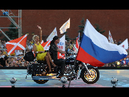 A hostess rides on a motorcycle during a celebration to mark the Russia's Day on the Red Square in Moscow, capital of Russia, June 12, 2010.  [Xinhua]
