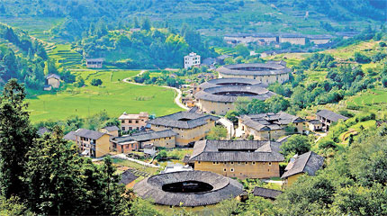 The photo shows some homes made of earth, or tulou, in Fujian Province. Fujian's tulous are famous around the country. com)     BEIJING, June 13 (Xinhuanet) -- Min cuisine, one of the eight culinary schools in China, is also known as Fujian cuisine and it originates in coastal Fujian Province.  Light but flavorful, soft and tender and often mixing sweet and sour, Min cuisine dates back 5,000 years. It has earned distinction for sublime seafood and excellent presentation. Cooking methods include simmering, grilling, stewing, baking with red rice wine, braising and salting. Don't forget that pan frying, deep frying and quick frying all play a role in Min cuisine.  The cuisine originated from Minhou County and evolved into three schools, including Fuzhou, Minnan (south of Fujian) and Minxi (west of Fujian).  The Fuzhou school mainly refers to Quanzhou and Xiamen styles, which feature fresh tastes with sweet and sour flavors.  The Minnan school developed in Zhangzhou and is famous for its various sauces and seasonings, featuring sour and slightly spicy flavors.  The Minxi school evolved in Changting. It is generally more salty and spicy and uses delicacies from mountainous areas as its major ingredients.  Red vinasse with red rice wine and the liberal use of sugar and vinegar are two favored methods of Min cooking.  As early as the Tang Dynasty (AD 618-907), red vinasse was introduced to Fujian by merchants from central China. Since then red has been the main color of Min cuisine. Red fish, red pork and red chicken are commonly seen on dining tables across Fujian.  The province is also known for its 'drunken' (wine marinated) dishes and is famous for quality soup stocks and bases used for flavoring.  As the province is blessed with abundant natural resources -- a long coastline to the east and vast mountainous regions in the north -- Min cuisine features a lot of mushrooms, bamboo shoots, sugar cane, lotus seeds, river eel, soft-shelled turtle and clams.  Min cuisine boasts a slicing technique dubbed as 'thin as a piece of paper and as light as a strand of hair.'  According to Min chefs, the natural taste of food can be brought out by fine, proper knife skills and they are strongly opposed to over-fancy and showy cutting techniques. Min cuisine chefs have to follow a set of strict slicing regulations.  Another saying about the region's cuisine goes: 'It is unacceptable to have a meal without soup.'  As such, Fujian chefs are soup experts. They are very good at using various sauces and seasonings to create all kinds of soups.  Salty seasonings include shrimp sauce, shrimp oil and soy sauce. Sour seasonings are made from white vinegar and qiaotou (a vegetable similar to green onion and garlic). Sweet seasonings include brown sugar and crystal sugar, while brown sugar, spiced powder, aniseed and cassia bark are used to create sweet-smelling seasonings. Spicy seasonings are usually made from pepper and mustard.  Fujian people love soup because they believe it is the most nutritious way to eat and that it brings out the true taste of the ingredients. A bowl of soup with every meal is indispensable for Min people.  Take the famed quick-boiled clams with sanrong soup as an example. The soup is made from ham, beef and chicken after being simmered for hours. The soup is known for its tender fresh clams that leave a long aftertaste.  (Source: Shanghaidaily.com)  
