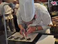 A chocolatier exhibits the chocolate making process in the Belgium / EU Pavilion in the Shanghai Expo 2010. Belgium, who hosts the EU Headquarters in Brussels and a handful of other important international organisations, is regarded the crossroad of the European Union. Its chocolate is as famous as diamonds.[Photo by Pierre Chen] 