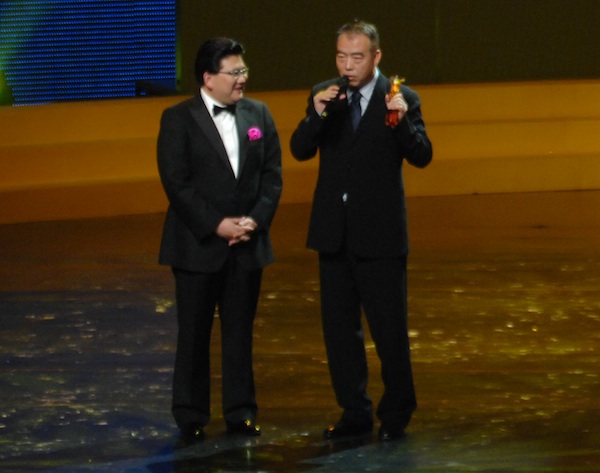 Director Chen Kaige (right) speaks after accepting the Award for Outstanding Contribution to Chinese Cinema at the opening ceremony of the 13th Shanghai International Film Festival at Shanghai Grand Theatre on June 12, 2010.