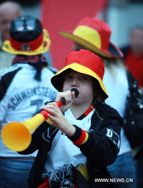 A fan cheers for the German team as she watches 2010 FIFA World Cup Group D first round match between Germany and Australia, in Saarbruecken, capital of western Germany&apos;s Saarland state, on June 13, 2010. Germany won the match 4-0 in Durban, South Africa, June 13. (Xinhua/Luo Huanhuan) 