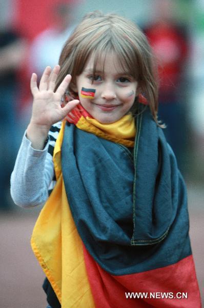 A fan cheers for the German team as she watches 2010 FIFA World Cup Group D first round match between Germany and Australia, in Saarbruecken, capital of western Germany&apos;s Saarland state, on June 13, 2010. Germany won the match 4-0 in Durban, South Africa, June 13. (Xinhua/Luo Huanhuan)