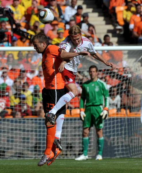 Netherlands' Rafael Van der Vaart (L) heads for the ball with Christian Poulsen of Denmark during the Group E first round 2010 World Cup football match at Soccer City stadium in Johannesburg, South Africa, on June 14, 2010. (Xinhua/Xu Suhui)