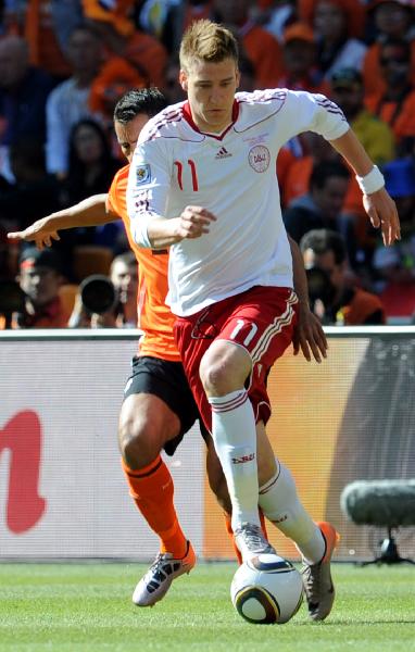 Nicklas Bendtner of Denmark(front) runs with the ball during the Group E first round 2010 World Cup football match at Soccer City stadium in Johannesburg, South Africa, on June 14, 2010. (Xinhua/Wang Yuguo)