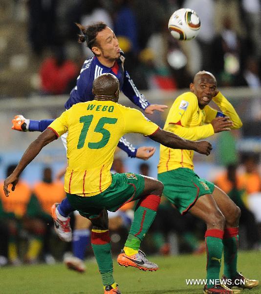 Japan's Tulio Tanaka (top) heads for the ball during the Group E first round 2010 World Cup football match against Cameroon at Free State stadium in Bloemfontein, South Africa, on June 14, 2010.