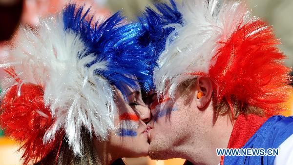 A couple kiss before the Group E first round 2010 World Cup football match between Netherlands and Denmark at Soccer City stadium in Johannesburg, South Africa, on June 14, 2010.