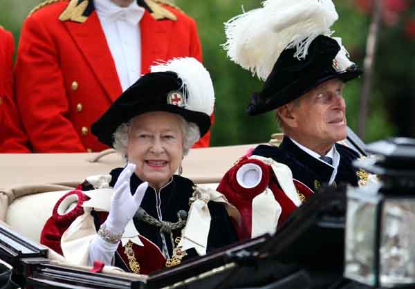 Britain's Queen Elizabeth and the Duke of Edinburgh (R) leave after the procession of the Order of the Garter in Windsor, London June 14, 2010. The order was founded by King Edward III in 1348 and includes the Prince of Wales and 24 knights.