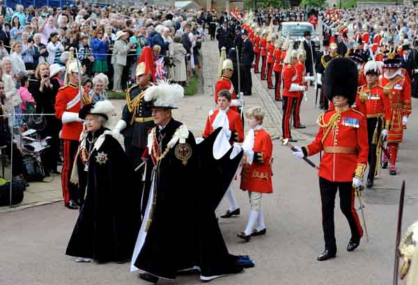 Britain's Queen Elizabeth and the Duke of Edinburgh (R) leave after the procession of the Order of the Garter in Windsor, London June 14, 2010. The order was founded by King Edward III in 1348 and includes the Prince of Wales and 24 knights.