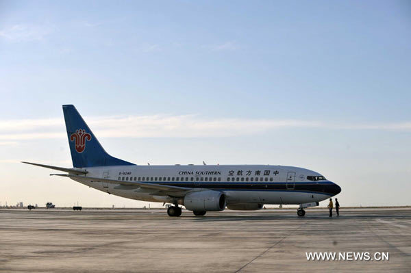 A chartered flight of CSA waits at the Urumqi airport on June 14.