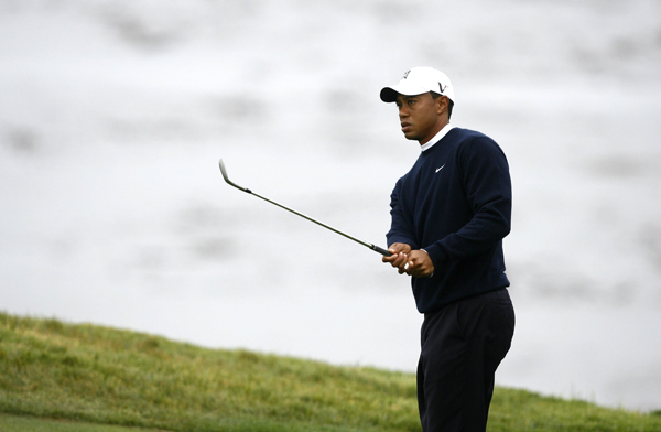 Tiger Woods of the U.S. watches a hit chip shot on the eighth hole during a practice round for the U.S. Open Golf Championship in Pebble Beach, California June 14, 2010.