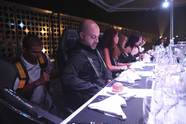 A crew member secures the harness of a guest at an event venue known as 'Dinner in the Sky', before the table and the rest of the guests are lifted by a crane in Beirut June 12, 2010.