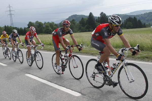 The pack of riders including RadioShack's team rider Lance Armstrong (R) and Saxo Bank's team rider Fabian Cancellara (L) of Switzerland cycles during the third stage of the Tour de Suisse from Sierre to Schwarzenburg June 14, 2010.