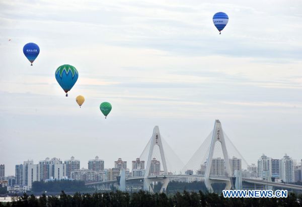 Hot air balloons rise during the Hot Air Balloon Challenge in Haikou, south China's Hainan Province, June 15, 2010. Twelve hot air balloons succeeded in flying over south China's Qiongzhou Strait. [Xinhua]