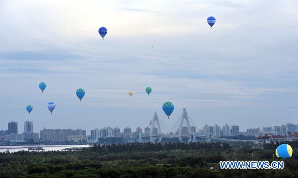 Hot air balloons rise during the Hot Air Balloon Challenge in Haikou, south China's Hainan Province, June 15, 2010. Twelve hot air balloons succeeded in flying over south China's Qiongzhou Strait. (Xinhua