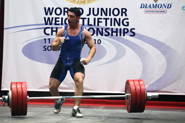Romanian Martin Razvan celebrates during the men's 69kg category event at the Junior World Weightlifting Championships held in Sofia, capital of Bulgaria, June 16, 2010. Martin Razvan claimed the title of the event with a total of 340kg. (Xinhua/Velko)