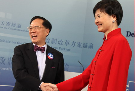 Hong Kong Chief Executive Donald Tsang (left) and Civic Party lawmaker Audrey Eu pose before going on live TV for a debate on Hong Kong’s political reform on June 17, 2010. [China Daily]