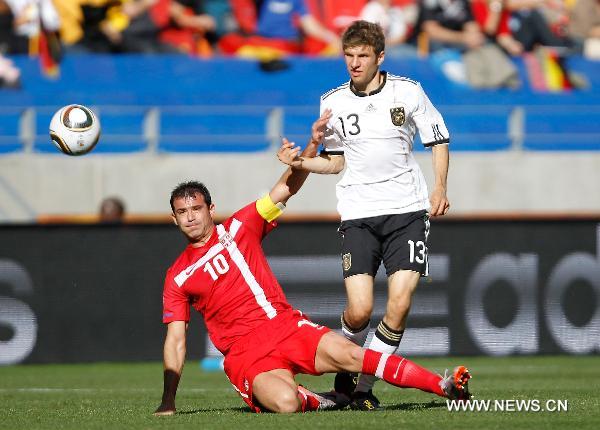 Germany's Thomas Muller (R) vies with Serbia's Dejan Stankovic during the 2010 World Cup Group D soccer match between Germany and Serbia at the Nelson Mandela Bay stadium in Port Elizabeth, South Africa, on June 18, 2010. (Xinhua/Liao Yujie)