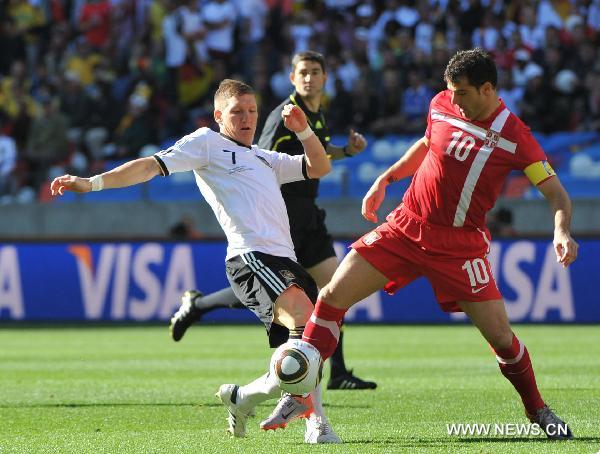 Germany's Bastian Schweinsteiger (L) vies with Serbia's Dejan Stankovic during the 2010 World Cup Group D soccer match between Germany and Serbia at the Nelson Mandela Bay stadium in Port Elizabeth, South Africa, on June 18, 2010. (Xinhua/Yang Lei)