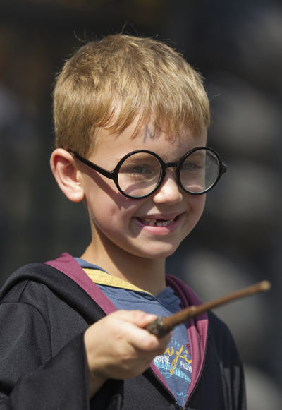 A young guest dressed as Harry Potter plays with his wand during the grand opening of The Wizarding World of Harry Potter theme park at the Universal Studio Resort in Orlando, Florida June 18, 2010. 