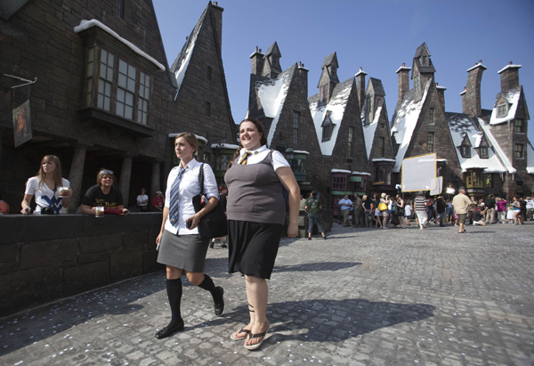 Guests tour the Wizarding World of Harry Potter theme park at the Universal Studio Resort during its grand opening in Orlando, Florida June 18, 2010.