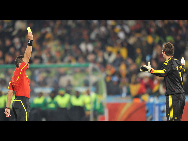 Denmark's goalkeeper Thomas Sorensen(R) is shown a yellow card during the 2010 World Cup Group E soccer match against Cameroon at Loftus Versfeld stadium in Tshwane, South Africa, June 19, 2010. Denmark won 2-1. [Xinhua]