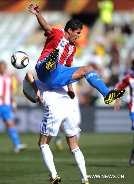 Paraguay's Carlos Bonet (Top) vies for the ball during the 2010 World Cup Group F football match against Slovakia at Free State Stadium in Bloemfontein, South Africa, on June 20, 2010. (Xinhua/Li Ga)