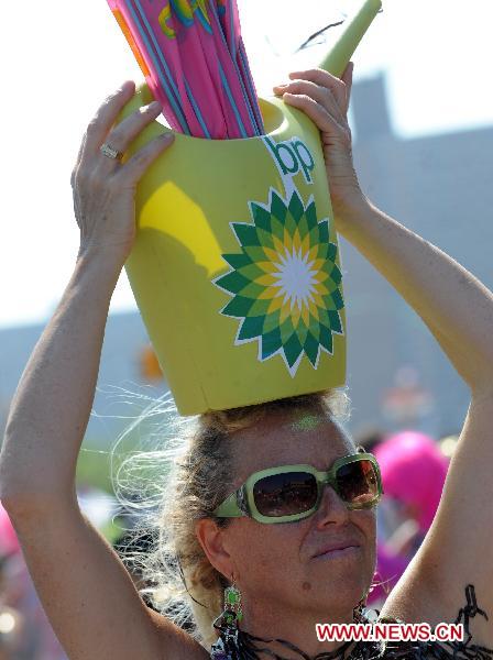 A woman attends a protest against the oil spill pollution caused by the British Petroleum in the Gulf of Mexico during the annual Mermaid Parade in Coney Island, New York, the United States, June 19, 2010. The Mermaid Parade, characterized by participants dressed in hand-made costumes as Mermaids and various sea creatures, celebrates the sand, the sea, the salt air and the beginning of summer. [Xinhua]