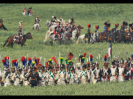 History enthusiasts, dressed as members of Allied Army, exercise at the bivouac of the famous battle of Waterloo in Waterloo, some 20 km south of Brussels, capital of Belgium, June 19, 2010. About 3,000 men across the Europe gathered in Waterloo this weekend to re-enact the crucial battle in 1815. [Xinhua]