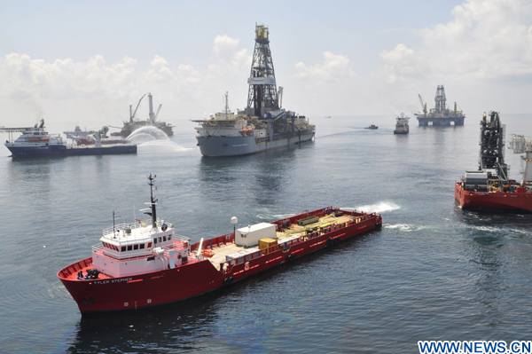 Ships and drilling rigs surround the Discoverer Enterprise as it continues to recover oil from the Deepwater Horizon drill site in the Gulf of Mexico on June 15, 2010. [Xinhua]