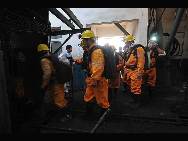 Firefighters work to rescue the trapped miners after explosives went off at the powder magazine of the Xingdong No.2 Mine in Weidong District of Pingdingshan City, Henan Province, June 21, 2010. [Xinhua Photo]