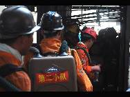 Firefighters work to rescue the trapped miners after explosives went off at the powder magazine of the Xingdong No.2 Mine in Weidong District of Pingdingshan City, Henan Province, June 21, 2010. [Xinhua Photo]