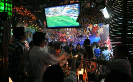 Soccer fans watch the World Cup at a bar in Fuzhou, Fujian.