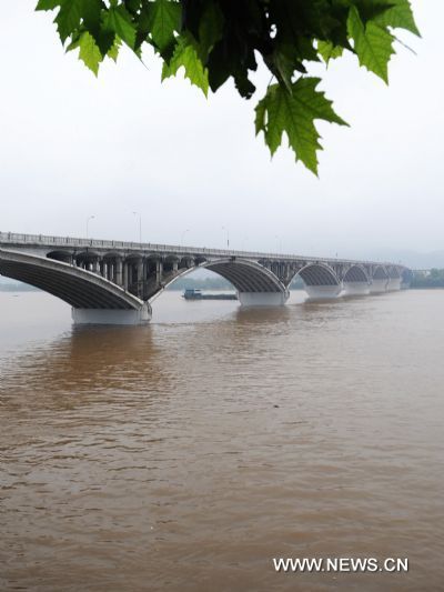 Bridge piers on Xiangjiang River are mostly submerged by flood peak after rainstorms in Changsha, capital of central China&apos;s Hunan Province, June 19, 2010.