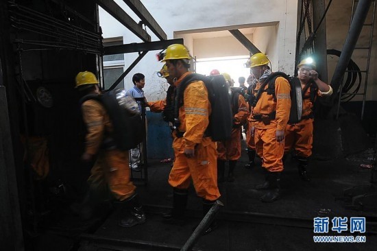 A total of 72 miners were trapped after explosives went off at the powder magazine of the Xingdong No.2 Mine in Weidong District of Pingdingshan City, Henan Province, on June 21, 2010. In the photo rescuers go down the mine to save the trapped people. [Xinhua]