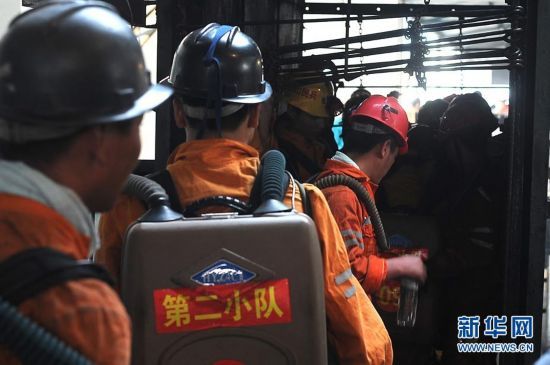 A total of 72 miners were trapped after explosives went off at the powder magazine of the Xingdong No.2 Mine in Weidong District of Pingdingshan City, Henan Province, on June 21, 2010. In the photo rescuers go down the mine to save the trapped people. [Xinhua]