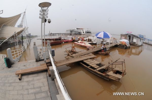 Vessels are anchored on the bank of the flooded Xiangjiang River in Changsha, central China's Hunan Province, June 21, 2010. Due to heavy rains and the flood discharge, the water level of Xiangjiang River at the Changsha section reached 36.33 meters at 1:00 pm on Monday, 0.33 meters above the warning level. [Xinhua]