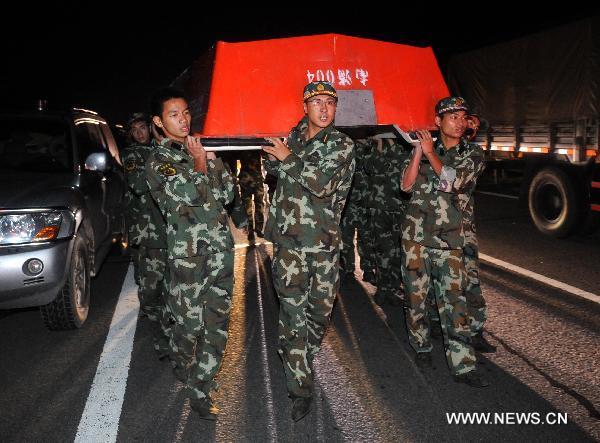 Paramilitary policemen conduct rescue operations after a dike bust in Fuzhou City, east China's Jiangxi Province, June 22, 2010.