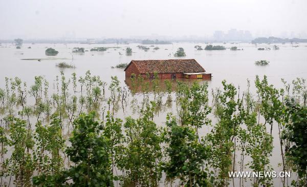 Luozhen town falls into a vast expanse of water, June 22, 2010. [Xinhua photo]