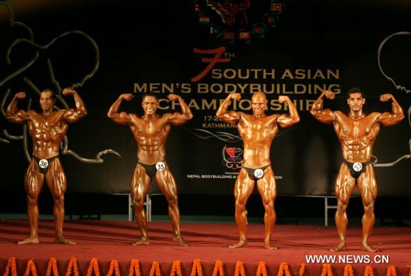 (From L to R) Mohammed Imran Qureshi of Pakistan, Sunanda Raj Shakya of Nepal, Milan Sizapati of Nepal and Govinda Jha of India compete during the Light Middle Weight (80Kg) category at the 7th South Asian Men&apos;s Bodybuilding Championship in Kathmandu, capital of Nepal, June 19, 2010. [Xinhua]