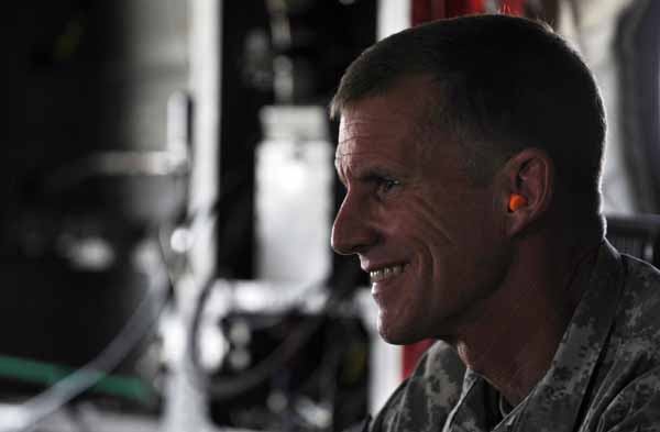 The U.S. and NATO commander in Afghanistan U.S. General Stanley McChrystal wears earplugs as he leaves by helicopter after a meeting between Afghan President Hamid Karzai and tribal leaders in Kandahar city June 13, 2010. [Xinhua]