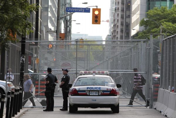 Police officers stand along a street in front of the security fence ahead of the G20 summit in Toronto Police officers stand along a street in front of the security fence ahead of the G20 summit in Toronto, June 21, 2010. Leaders of the Group of Eight and Group of 20 nations meet in Canada June 24-27 to discuss the course of the future as the world emerges from the worst financial crisis since the Great Depression. (Xinhua/Reuters)