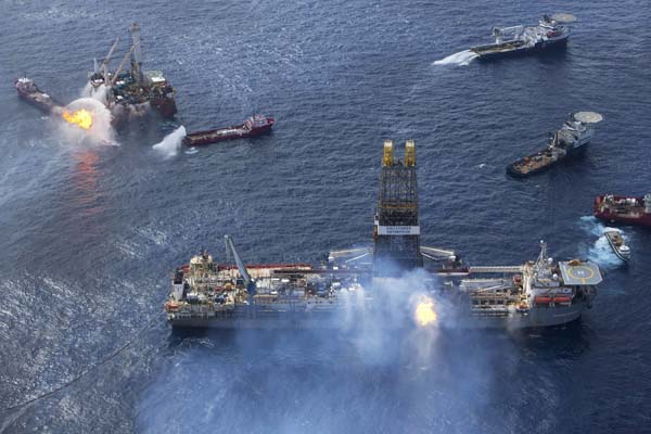 Support ships surround the Q4000 oilfield construction vessel (L,rear) and the Transocean Drillship the Discoverer Enterprise as they work near the site of the Deepwater Horizon disaster in the Gulf of Mexico in this June 22, 2010 handout photo. [Xinhua/Reuters] 