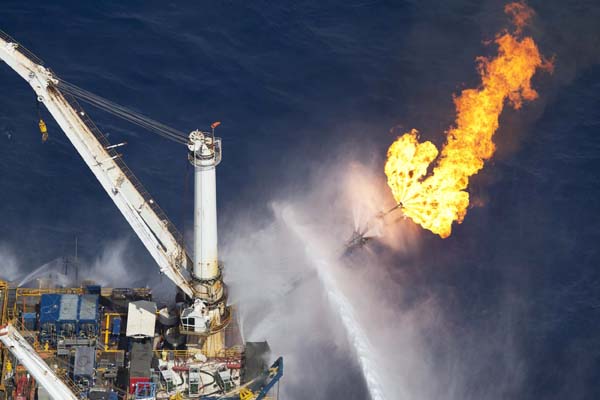 The Q4000 multi-purpose oil field intervention vessel burns off material from the Deepwater Horizon wellhead near the disaster site in this June 22, 2010 handout photo.[Xinhua/Reuters] 